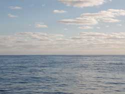 Easy ocean motor sailing on a peaceful blue sea