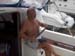 Cleaning the boat mung from under the finger nails - note the rain water in the gunnels