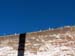 The broken glass discourages thieves from climbing over the wall